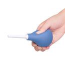 b-Vibe Compact Enema Douche Blue held in hand for convenient and discreet cleansing.