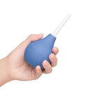 b-Vibe Compact Enema Douche Blue held in hand for travel-friendly hygiene.