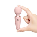 Le Wand Mini Micro Wand Rose Gold held in hand, showcasing its compact design and elegant features.