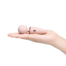 Le Wand Mini Micro Wand Rose Gold held in hand, showcasing its compact design and elegant rose gold finish.