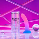 Love To Love Dildolls Utopia Large Silicone Dildo next to its packaging on a colorful background.