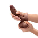 b-Vibe Slipskin Realistic Silicone Dildo 6 inch Girthy Brown held in hands showcasing its realistic design.