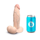 b-Vibe Slipskin Realistic Silicone Dildo 7 inch Girthy Cream next to a soda can for size comparison.