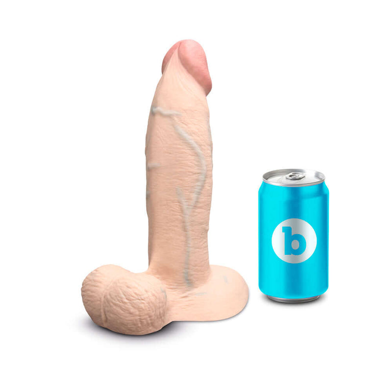 b Vibe Slipskin Realistic Silicone Dildo 9 inches Girthy Cream next to a soda can for size comparison.