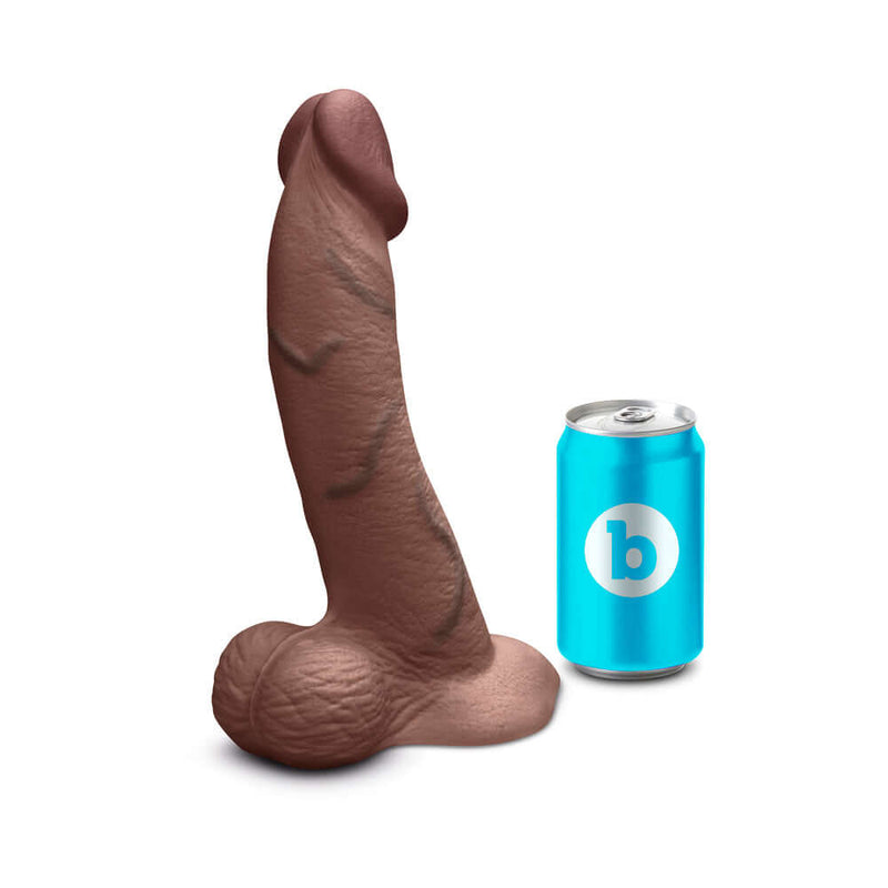 b-Vibe Slipskin Realistic Silicone Dildo 10 inch Curved Brown next to a soda can for size reference.