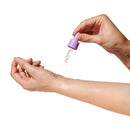 Application of Eye of Love Pheromone Parfum Oil 0.67 Oz Dropper Lilac Dream onto skin using a dropper.