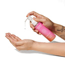 Eye of Love Pheromone Body Oil 4 Oz Pump Sunny Daze being dispensed onto hand