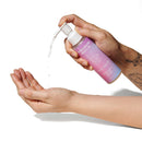 Eye of Love Pheromone Body Oil 4 Oz Pump Lilac Dream being dispensed onto a hand from a pump bottle.