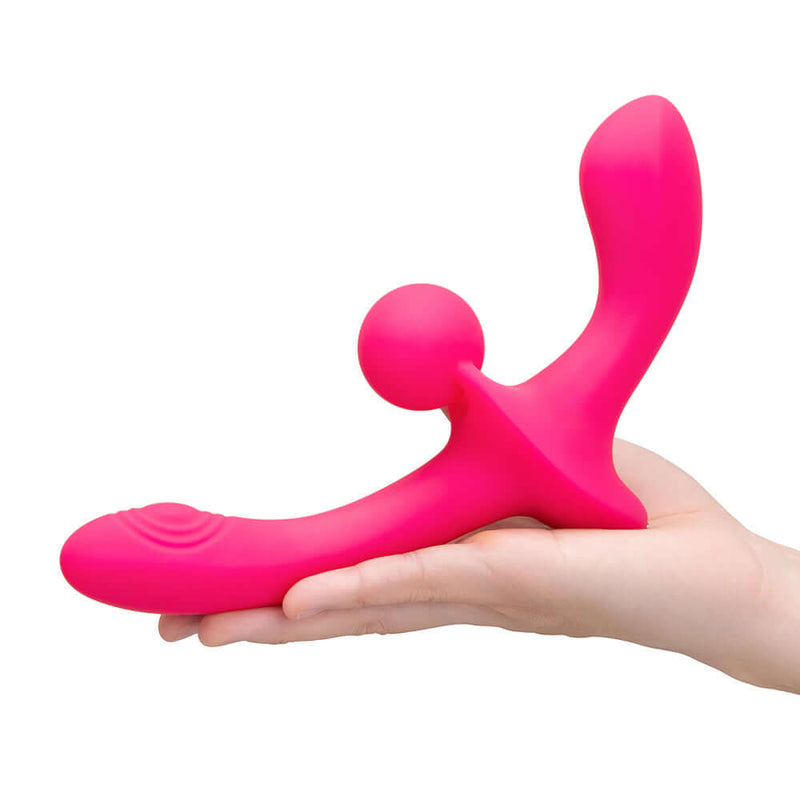 Together Double Tap Dual Ended Vibrating Strapless Strap on held in a hand, showcasing its innovative design and vibrant color.