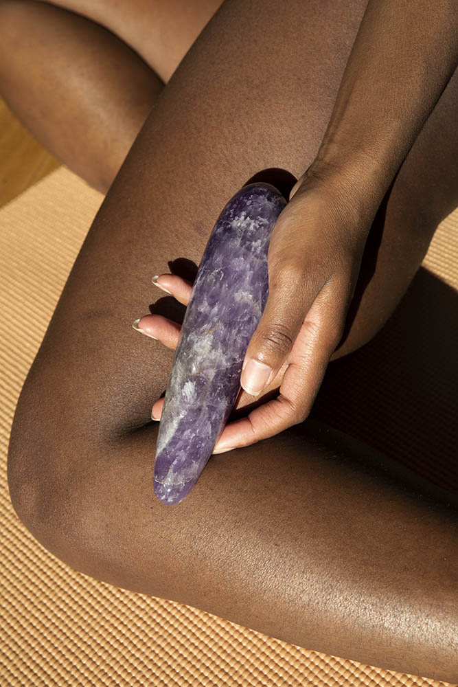 Dame Chakrubs Amethyst Original Wand held in hand, showcasing its elegant design and healing properties.
