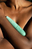 Chakrubs Indian Jade Original Green Aventurine Wand held against skin, highlighting its smooth texture and calming aura.
