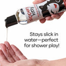 Slippery Kitty Silicone Lubricant 4 Oz pouring from a bottle into a hand, perfect for shower play.