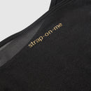 Strap-On-Me Harness Body Signature Black Large close-up of soft fabric with logo design.