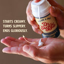 Dr Tuggs Gentleman's Masturbation Lotion 3.4 Oz being dispensed onto a hand, highlighting its creamy and slippery texture.