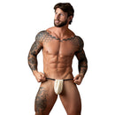 Male Power Mykonos Limited Edition G-String Ivory One Size on a muscular model with tattoos.