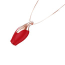 The Pleasure Company Patina Vibrating Rose Necklace on a delicate chain with a sculpted rose pendant.