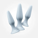 Vush Essentials Silicone Anal Plug Trio Gray set featuring three tapered silicone anal plugs in gray color.