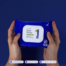 Dame Body Wipes 12 Count Aloe and Cucumber held in hand against a blue background, showcasing packaging design.