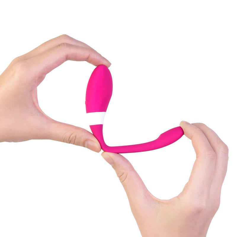 Intimina KALIA Couples Massager held in hands, showcasing its ergonomic design and vibrant pink silicone.