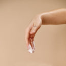 Hand holding foam from Sex Au Naturel Prebiotic Intimate Wash Gentle Foam, showcasing its gentle cleanser texture.