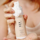 Sex Au Naturel Prebiotic Intimate Wash Gentle Foam in a hand with gentle foam dispensing from bottle.