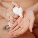 Person applying Sex Au Naturel Prebiotic Intimate Wash Gentle Foam to hand for cleansing.