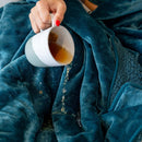 Splash Blanket The OG Small Emerald Green being spilled on, showcasing its waterproof design and plush texture.