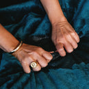 Hands gripping the plush material of Splash Blanket The OG Small Emerald Green, showcasing its waterproof quality.