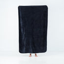 Splash Blanket The OG Waterproof Blanket Medium Black displayed held up, showcasing its plush black texture.