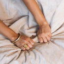 Splash Blanket The OG Medium Waterproof Champagne displayed with hands gripping its plush, waterproof surface.