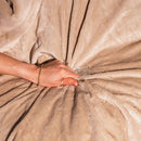 Hand holding the plush texture of the Splash Blanket Furlush Medium Waterproof Blanket Chai.
