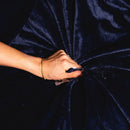 Hand squeezing the Splash Blanket Furlush Large Waterproof Blanket Navy showcasing its plush velvet texture.