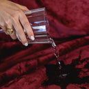 Splash Blanket The OG Large Waterproof Blanket Moon Blood protecting against spills with water being poured.