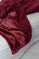 Splash Blanket The OG Large Waterproof Blanket Moon Blood on a couch, showcasing its plush design and rich color.
