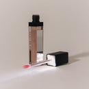 Eye of Love Matchmaker Pink Pulse Pheromone pH Lip Stain with an applicator on a light background.