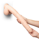 b-Vibe Bone 17 Inch Deep-Insert Dildo with Balls being held, showcasing its lifelike detail and design.