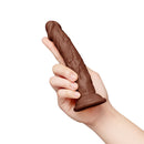 Together Toy 6.75 Inch Realistic Dildo Dark held in a hand, showcasing its lifelike design and texture.