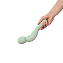 Dame Com Rechargeable Wand Vibrator Sage held in hand, featuring a sleek design and ergonomic shape.