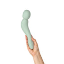 A hand holding the Dame Com Rechargeable Wand Vibrator Sage, showcasing its ergonomic design and soft sage color.