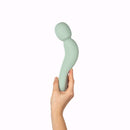 Dame Com Rechargeable Wand Vibrator Sage held in hand showcasing its ergonomic design and soft material.