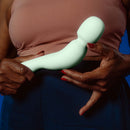 Dame Com Rechargeable Wand Vibrator Sage held in hands showcasing its ergonomic design and soft material.