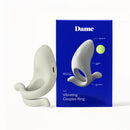 Dame Hug Vibrating Couples Ring Fog next to its blue packaging, showcasing adjustable fit and charging port.