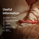 Lelo Boomerang Double Ended Vibrator Cerise with useful information displayed on a bed.