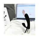 OhMiBod Fuse Interactive Dual Stimulator Black on white bedding with a laptop in the background.