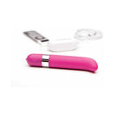 OhMiBod Freestyle G-Spot Vibrator Pink placed alongside audio devices for music-reactive enjoyment.