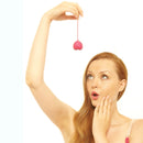 Ohmibod Lovelife Flex Kegel Exerciser 3-piece Set Pink being held by a surprised woman, focusing on pelvic floor strength.