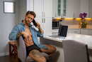 Male Power Ripple Pouch Short Teal M worn by a man in a kitchen while using a phone.