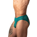 Male Power Ripple Moon Jock Teal S/M showcased on a model, highlighting its bold design and flattering fit.