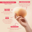 Uva Circular Nipple Covers Cocoa in hand highlighting their ultra-thin, discreet design for seamless wear under clothing.