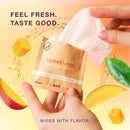 Sweetums Intimate Wipes Sweet Mint Flavor 10-pack packaging held in hand with fruit graphics in the background.